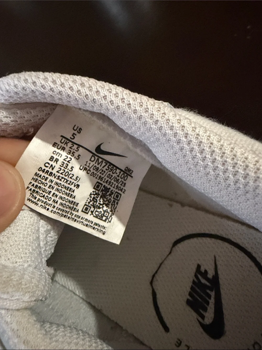 Nike White Low-Top Sneakers with Black Swoosh and Tan Accent